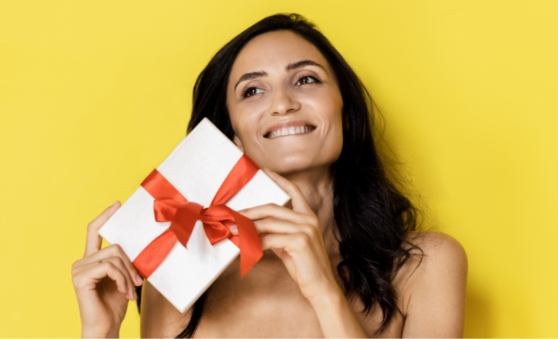 woman holding white present box with red gift ribb 2025 01 09 07 54 51 utc